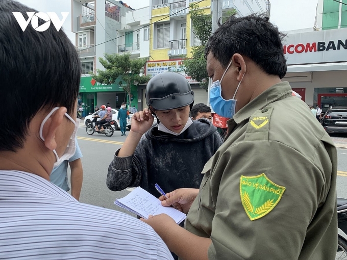 Lực lượng chức năng hướng dẫn người thân các nạn nhân trong vụ cháy quán karaokr An Phú làm 12 người tử vong. Ảnh: CTV